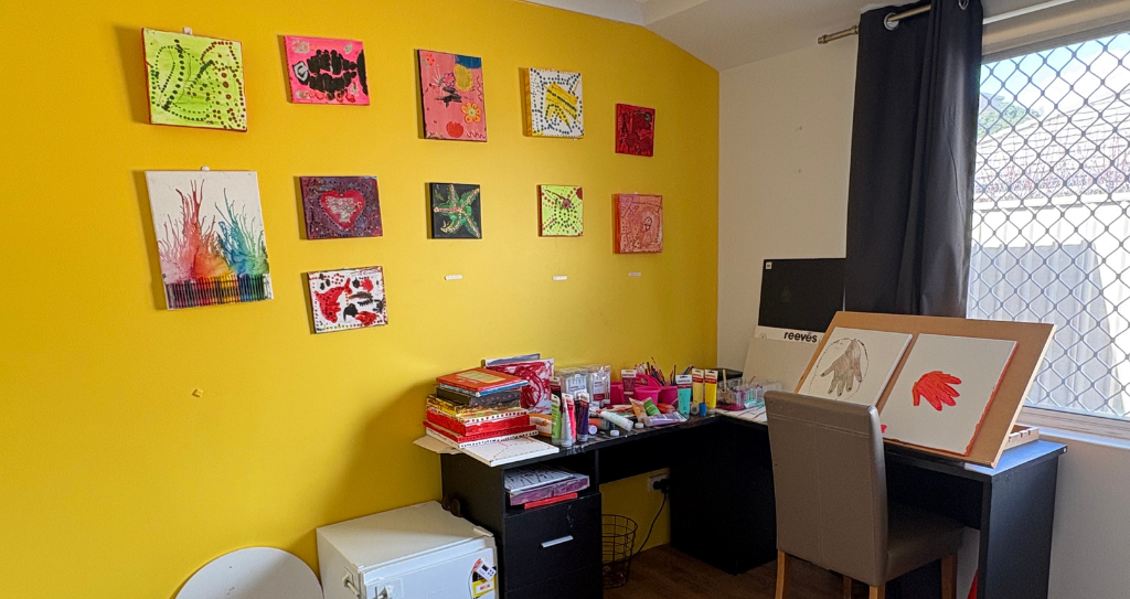 Image of Rosie's art room with colourful artwork displayed on the walls.